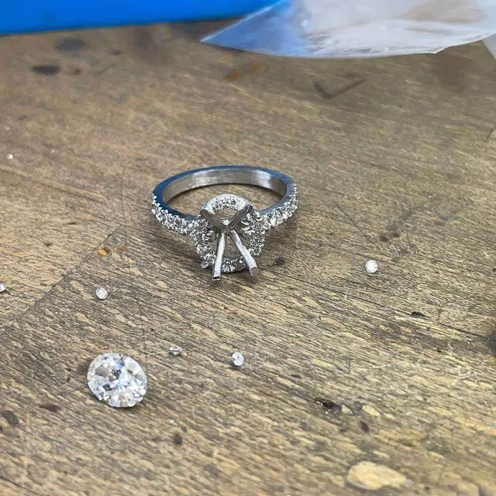 A ring on the bench with loose diamonds