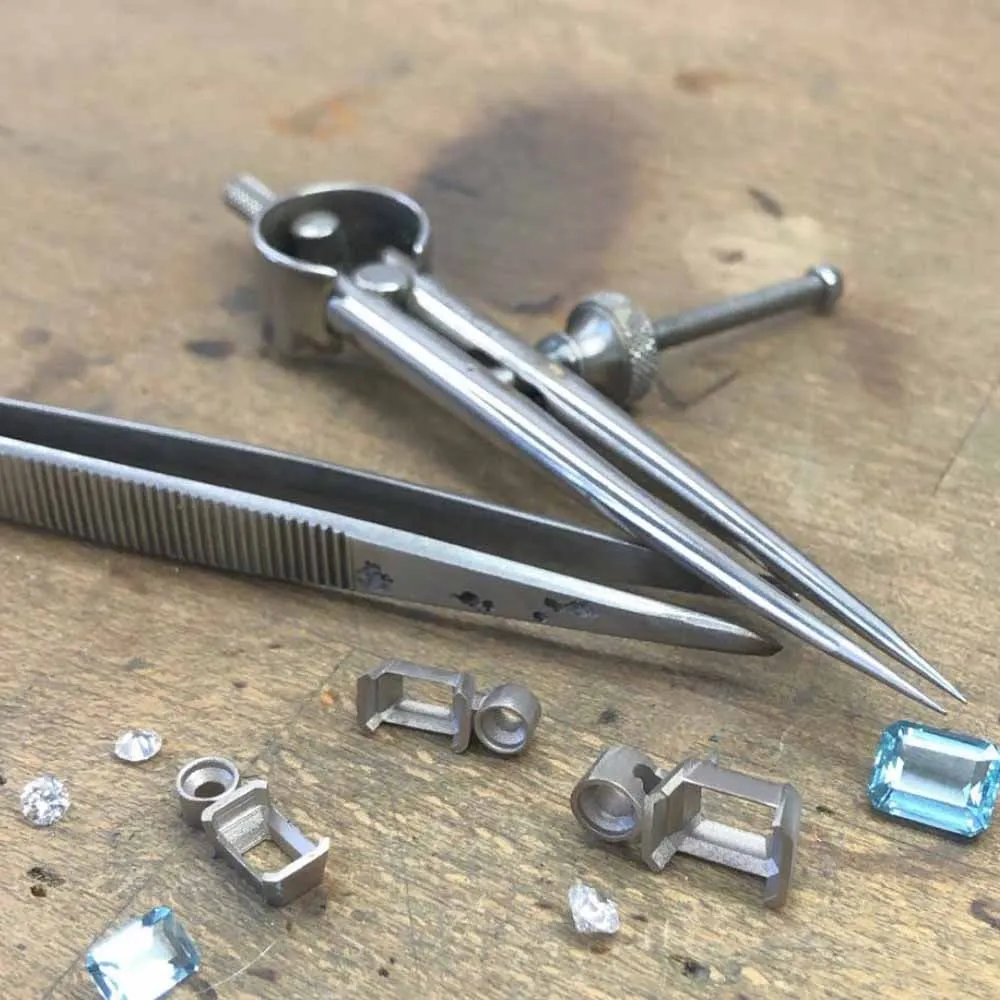 Jeweller's setting tools and coloured stones on the bench